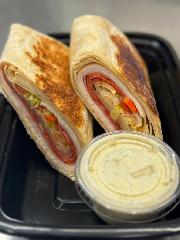 Toasted Italian wrap with side of Italian dressing
