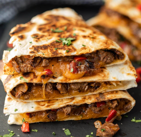 Loaded steak fajita quesadilla with avocado crema