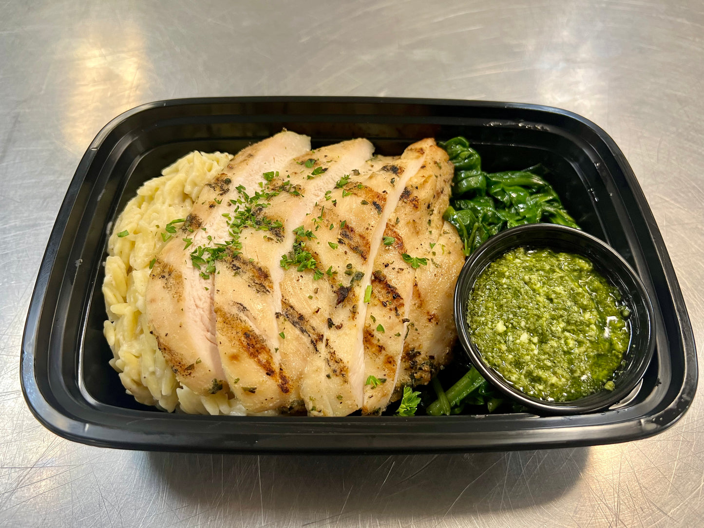 Grilled chicken over parmesan orzo & side basil pesto