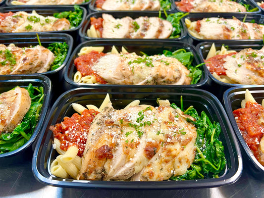 Chicken parmesan over pasta with sauteed spinach