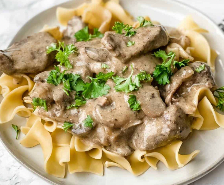 Beef stroganoff over egg noodles with roasted green beans