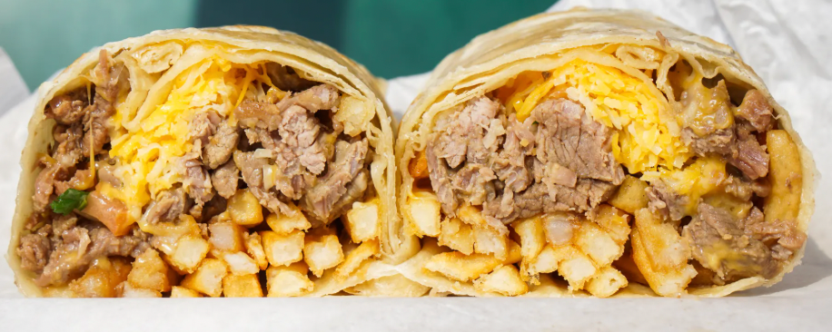 "California-style" carne asada burrito with side of avocado crema