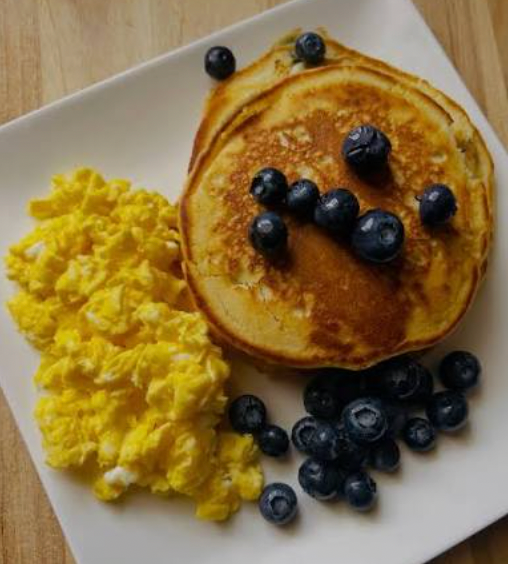 Blueberry protein pancakes with cheesy scrambled eggs & grilled chicken sausage